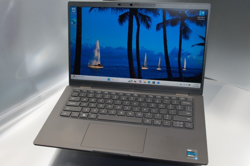 Charcoal Dell Latitude 7420 open on a desk, Windows desktop on screen